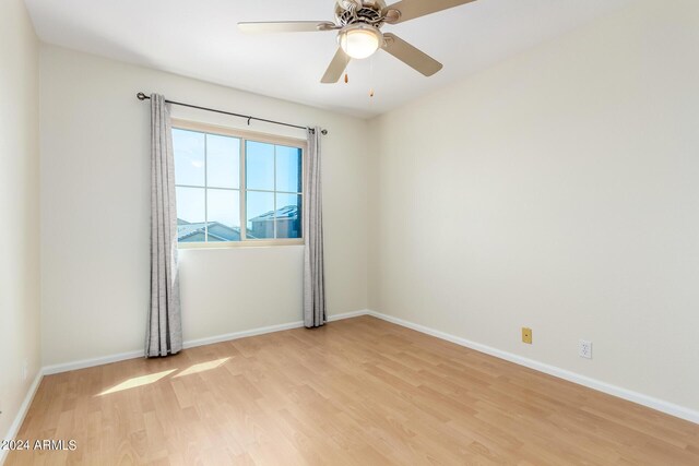 unfurnished bedroom with light wood-type flooring, ceiling fan, and a closet