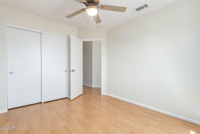 empty room with ceiling fan and light hardwood / wood-style floors