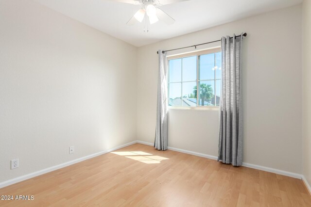 unfurnished bedroom featuring ceiling fan, a closet, and light wood-type flooring