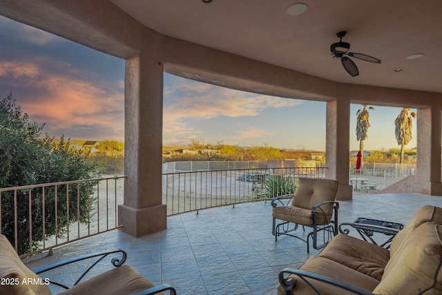 patio terrace at dusk with ceiling fan and a water view