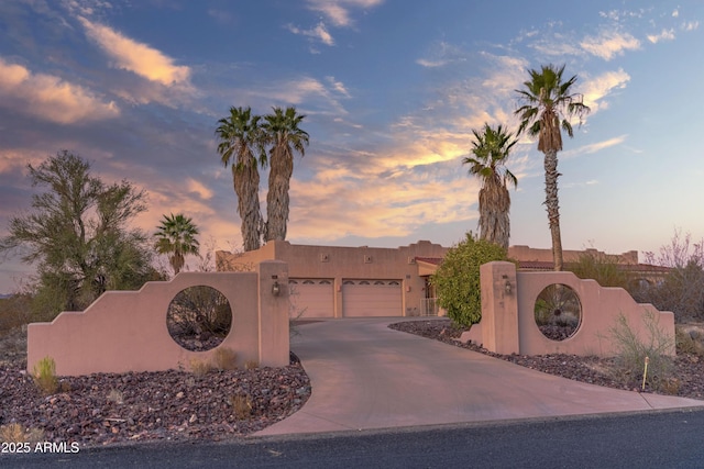 pueblo-style house with a garage