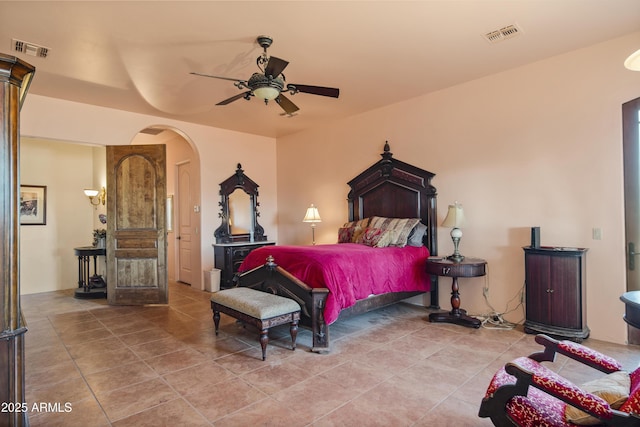 tiled bedroom featuring ceiling fan