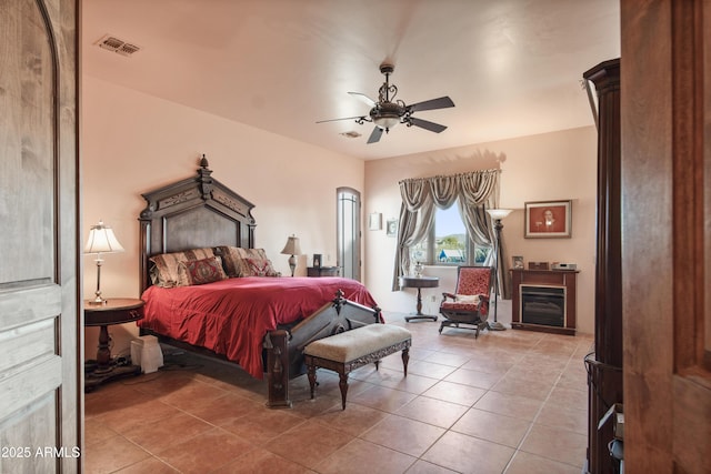 tiled bedroom with ceiling fan