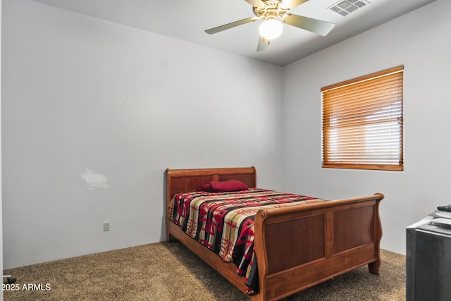 bedroom with ceiling fan and dark carpet