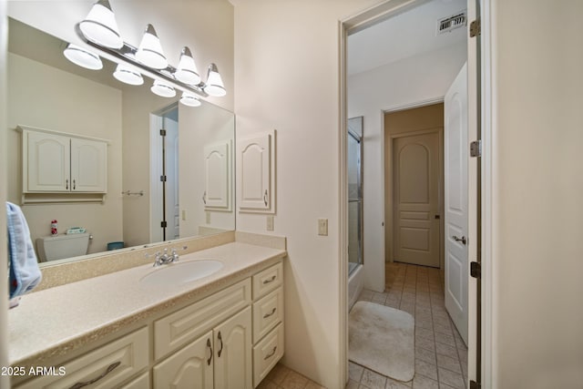 full bathroom featuring toilet, vanity, tile patterned floors, and bath / shower combo with glass door