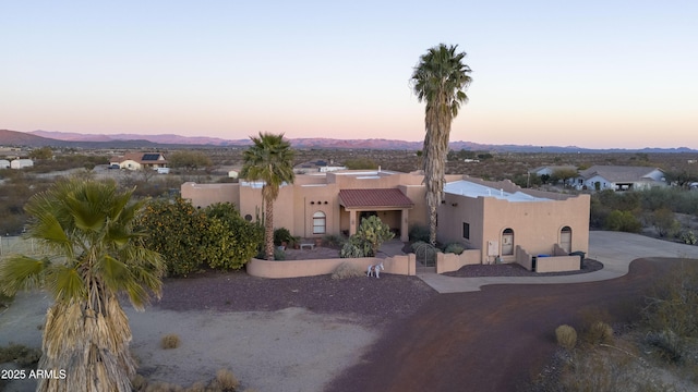 pueblo-style home featuring a mountain view