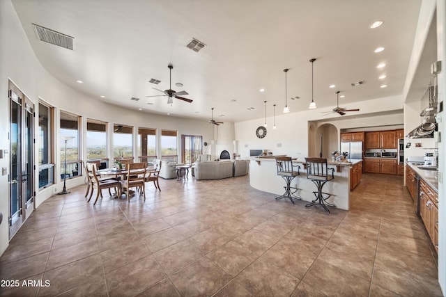 tiled dining space with ceiling fan