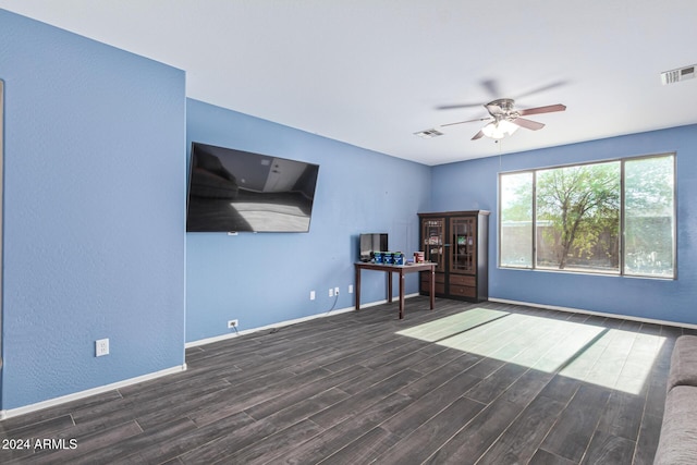 interior space featuring baseboards, visible vents, and wood finished floors