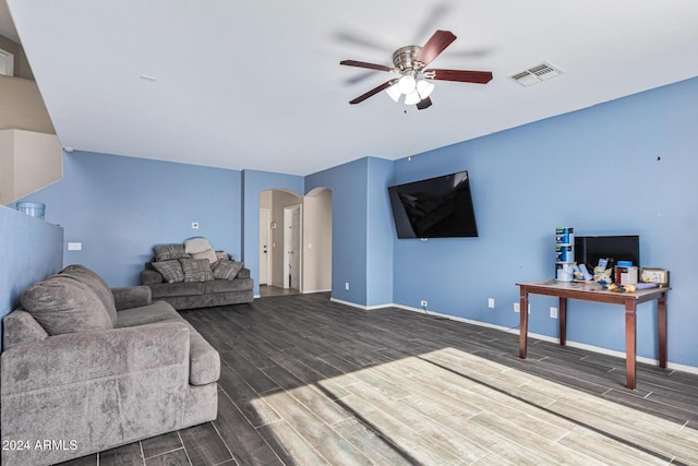 living area featuring arched walkways, visible vents, baseboards, and wood tiled floor