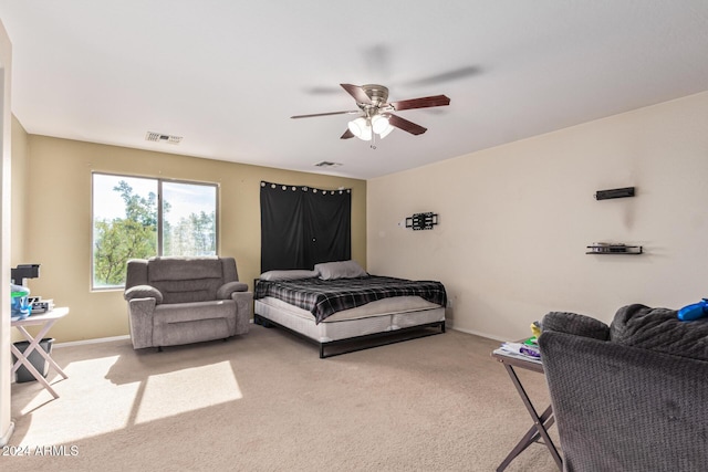 bedroom featuring baseboards, visible vents, a ceiling fan, and light colored carpet