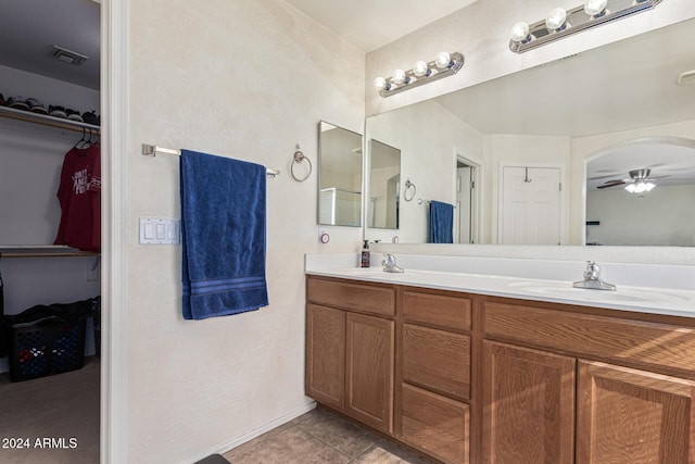 full bathroom featuring ceiling fan, tile patterned flooring, a sink, visible vents, and double vanity