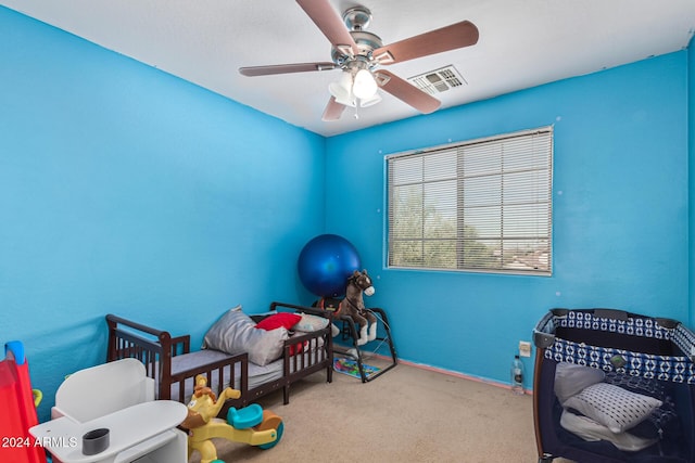interior space with ceiling fan, carpet floors, visible vents, and baseboards