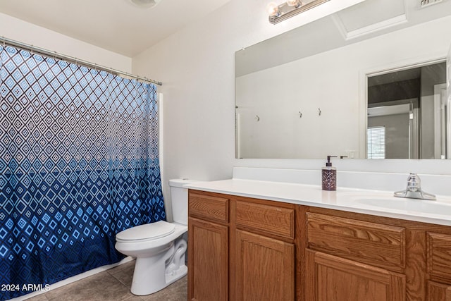 bathroom featuring curtained shower, vanity, toilet, and tile patterned floors