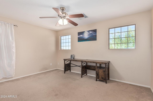 carpeted office space with ceiling fan, visible vents, and baseboards
