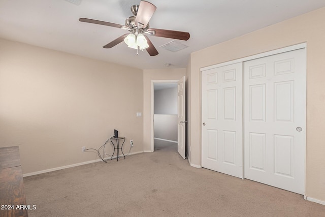unfurnished bedroom with a ceiling fan, carpet, baseboards, and a closet