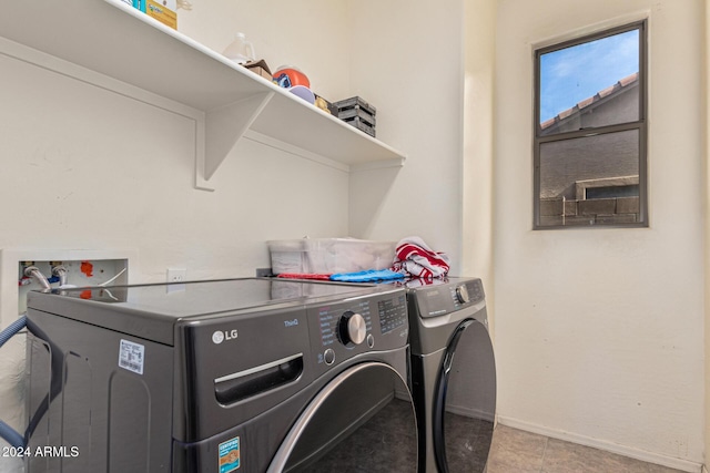clothes washing area with laundry area, washer and clothes dryer, and baseboards