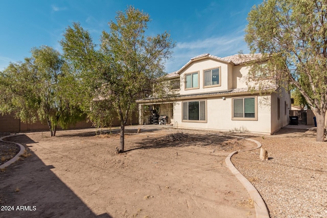 back of property featuring a tile roof, fence, a patio, and stucco siding