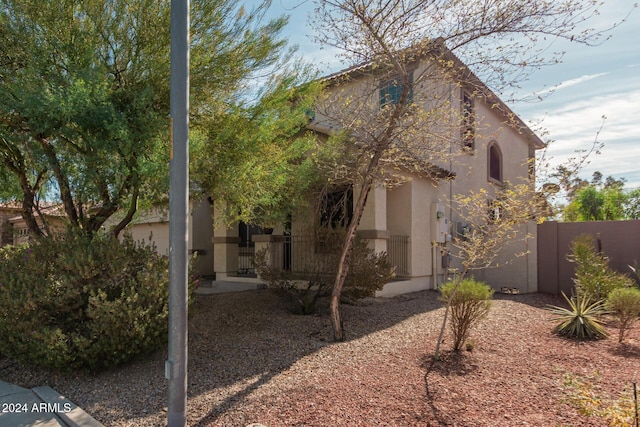 view of front of home featuring fence and stucco siding