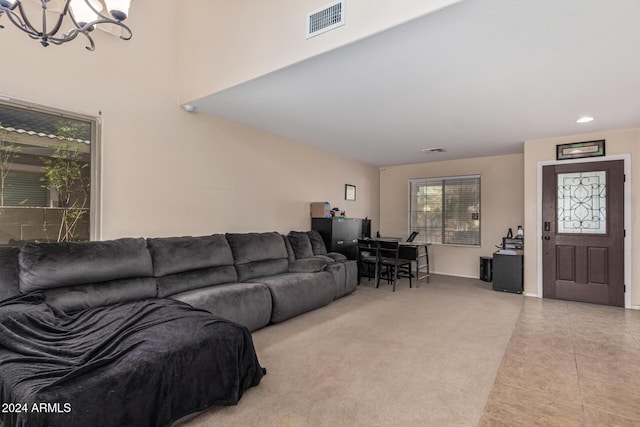 living area with light carpet, light tile patterned floors, visible vents, and a notable chandelier