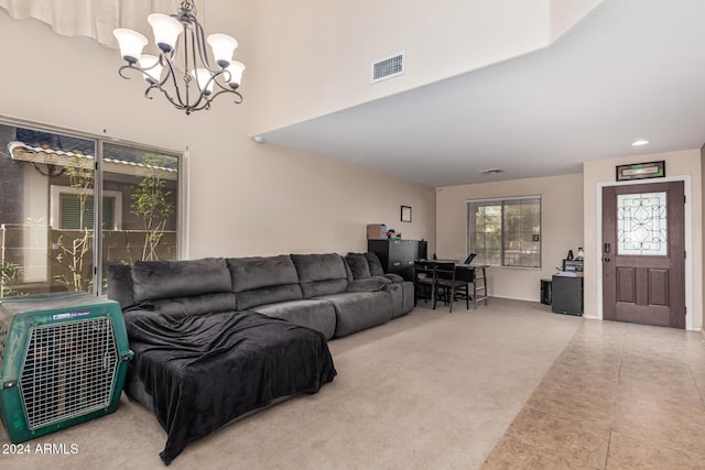 tiled living area with carpet floors, a towering ceiling, visible vents, and a notable chandelier