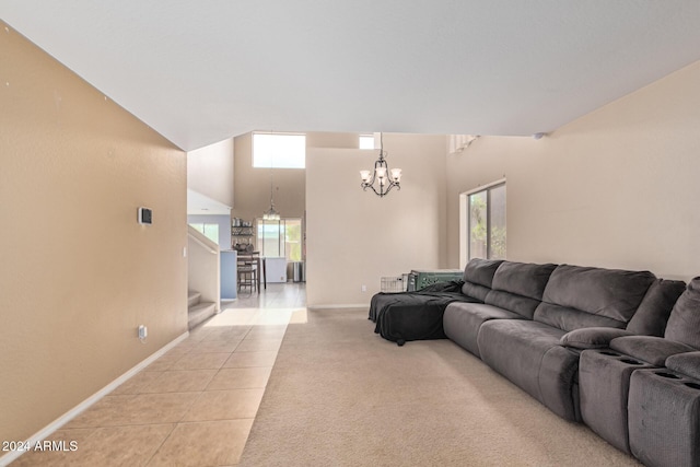 living room with plenty of natural light, light colored carpet, a notable chandelier, and light tile patterned floors