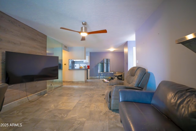 living area featuring ceiling fan