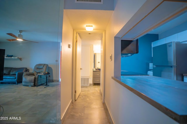 corridor featuring baseboards