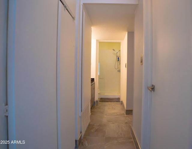 hall with baseboards and marble finish floors