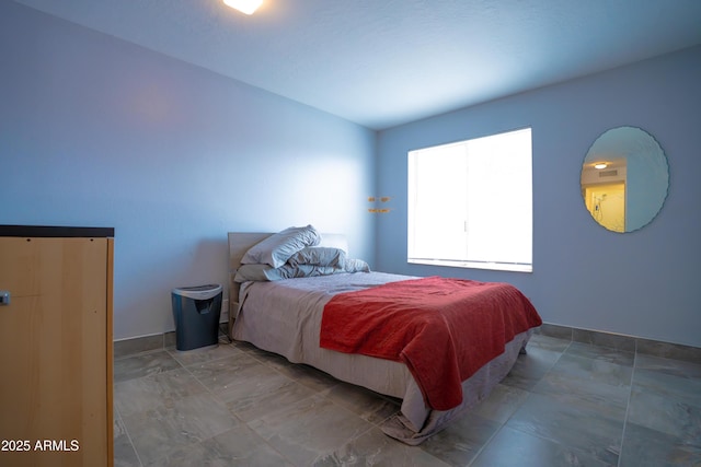 bedroom featuring baseboards