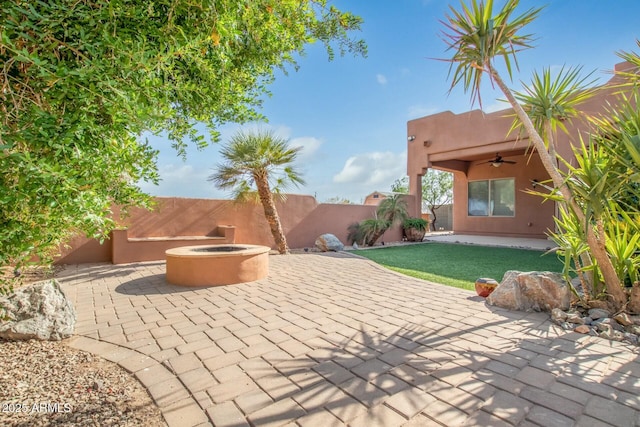 view of patio / terrace featuring ceiling fan and an outdoor fire pit