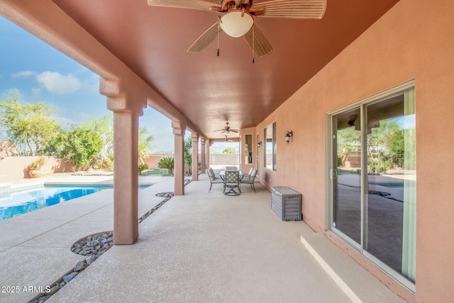 view of patio / terrace with a fenced in pool and ceiling fan