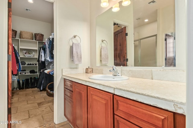 bathroom featuring vanity and a shower with shower door