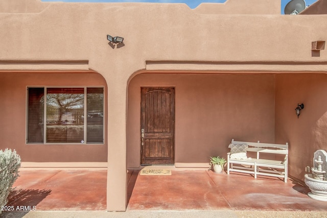 property entrance featuring a patio