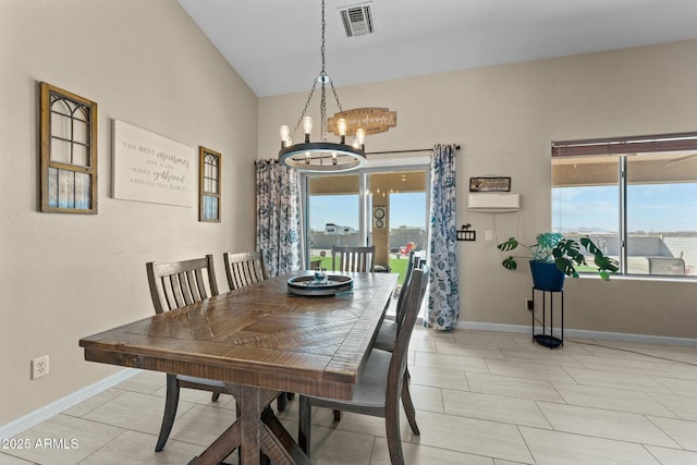 dining area featuring a healthy amount of sunlight, visible vents, a notable chandelier, and baseboards