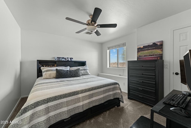 carpeted bedroom featuring ceiling fan, visible vents, and baseboards