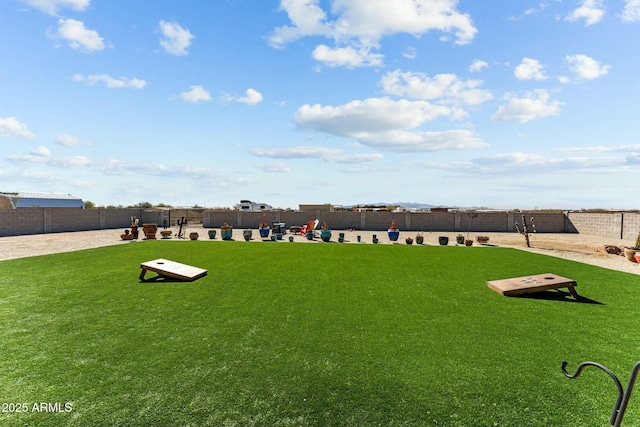 exterior space with fence and a lawn