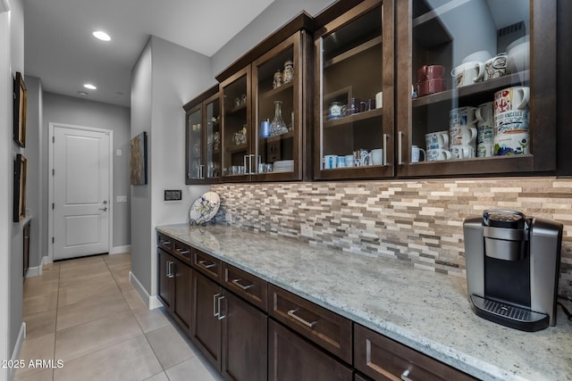 bar featuring tasteful backsplash, recessed lighting, light tile patterned flooring, and baseboards