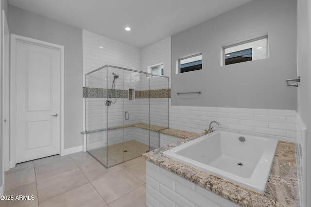 bathroom with a garden tub, a shower stall, tile patterned flooring, and recessed lighting