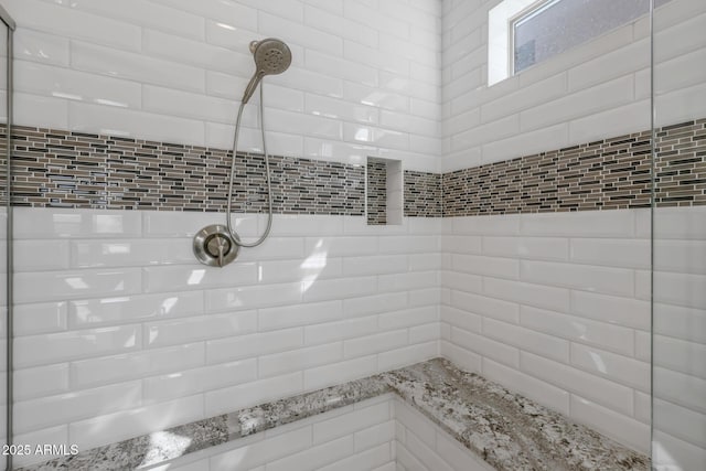 full bath with a tile shower