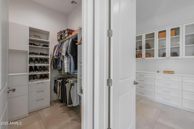 spacious closet with light tile patterned floors and visible vents