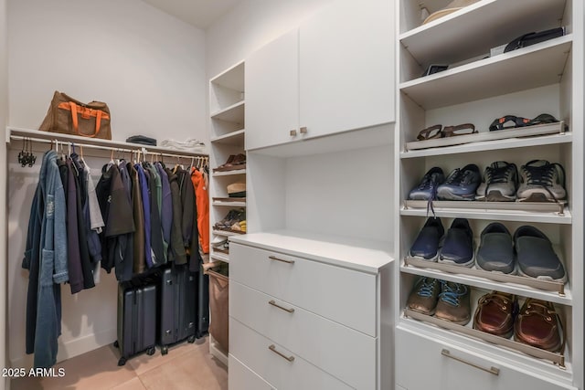 spacious closet featuring light tile patterned floors