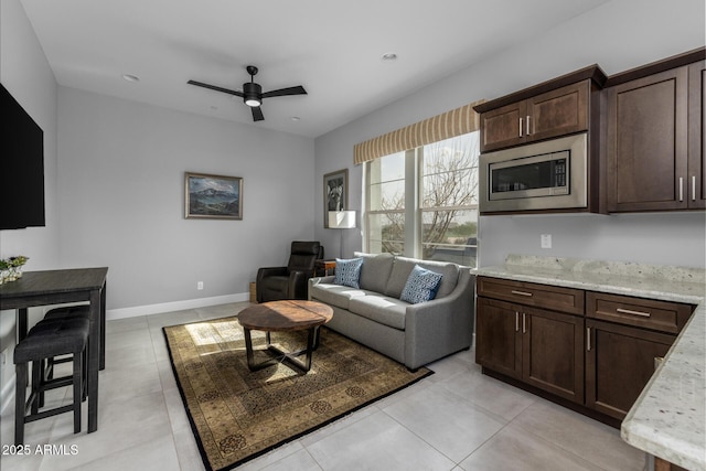 living area featuring light tile patterned floors, ceiling fan, baseboards, and recessed lighting