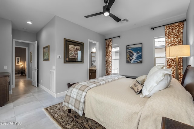 bedroom with light tile patterned floors, visible vents, a ceiling fan, ensuite bath, and baseboards