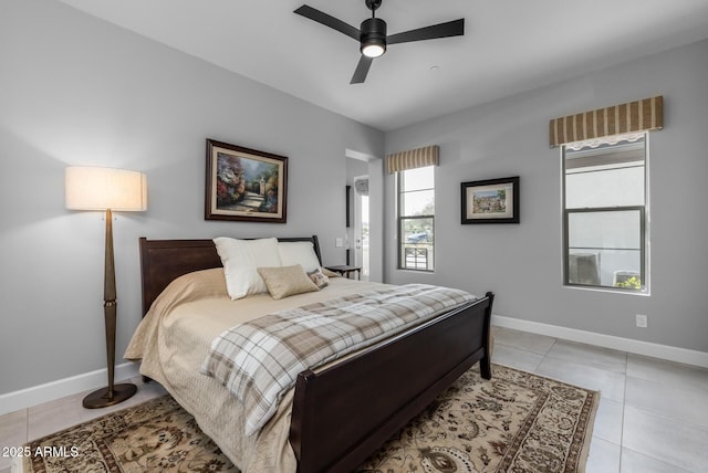 bedroom with ceiling fan, baseboards, and light tile patterned flooring