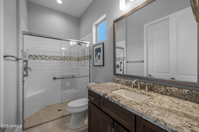 full bathroom with toilet, a stall shower, tile patterned flooring, and vanity