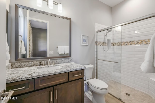 full bath with toilet, a shower stall, and vanity