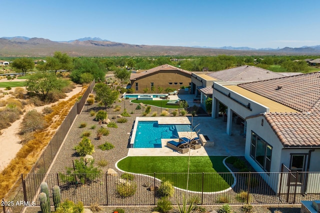 view of swimming pool with a fenced in pool, a patio area, a fenced backyard, and a mountain view