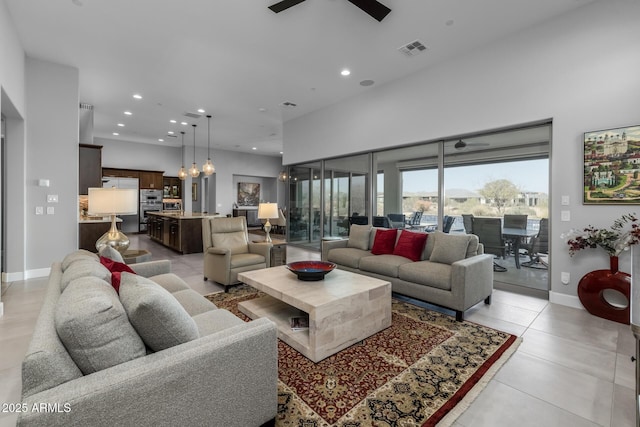 living room featuring light tile patterned floors, visible vents, baseboards, ceiling fan, and recessed lighting