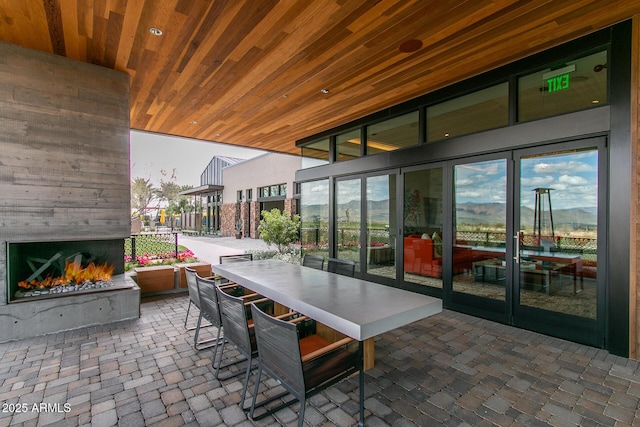 view of patio featuring a large fireplace and outdoor dry bar