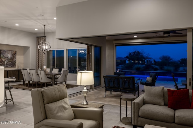 living room with light tile patterned floors, a chandelier, and recessed lighting